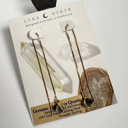 Luna Norte earrings on a branded card with a white background